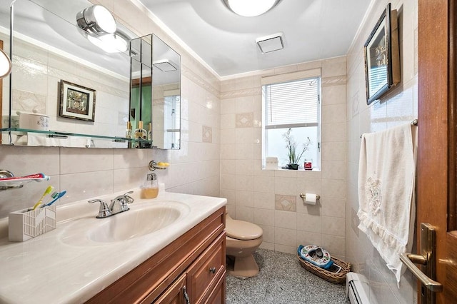 bathroom featuring toilet, vanity, ornamental molding, tile walls, and baseboard heating