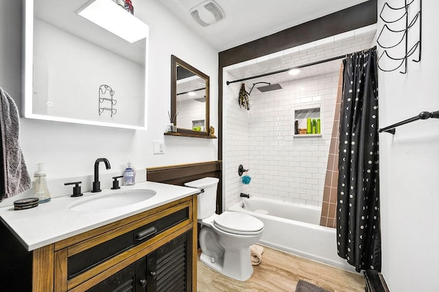 full bath featuring wood finished floors, visible vents, toilet, vanity, and shower / tub combo with curtain