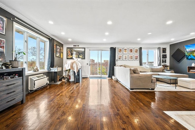 living room featuring wood finished floors, recessed lighting, ornamental molding, and a healthy amount of sunlight