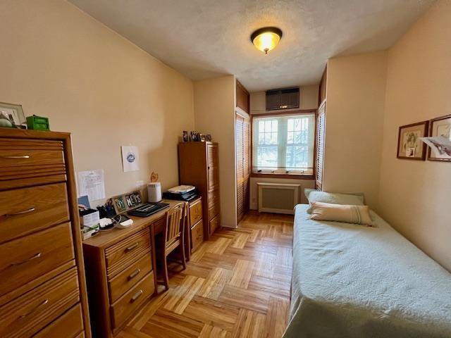 bedroom featuring a wall mounted air conditioner