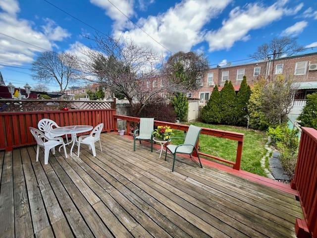 deck with outdoor dining area and fence