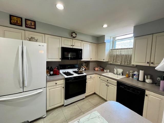 kitchen with black appliances, a sink, light tile patterned flooring, white cabinets, and recessed lighting