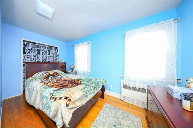 2939 Brighton 3rd St, Brooklyn, NY 11235 - bedroom featuring radiator heating unit, baseboards, and light wood-style floors
