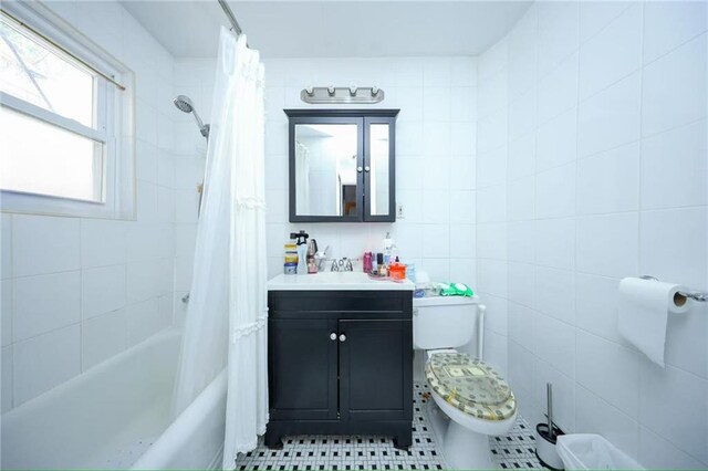 2939 Brighton 3rd St, Brooklyn, NY 11235 - bathroom with vanity, tile patterned flooring, shower / bath combination with curtain, toilet, and tile walls