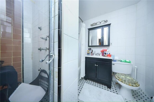 2939 Brighton 3rd St, Brooklyn, NY 11235 - full bath with tile walls, a shower stall, tile patterned flooring, and vanity