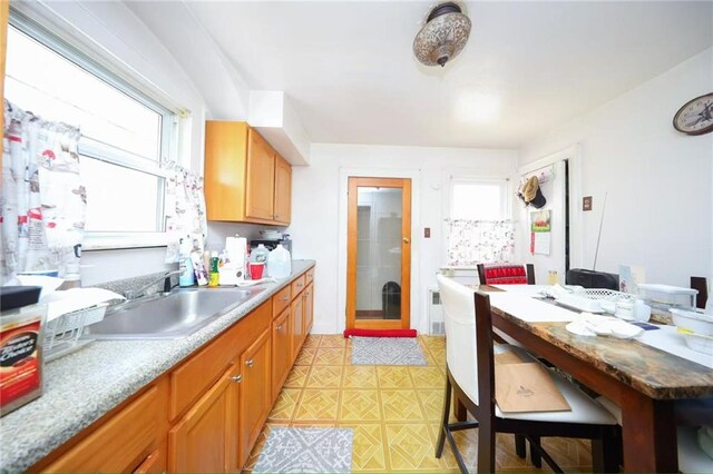 2939 Brighton 3rd St, Brooklyn, NY 11235 - kitchen featuring brown cabinetry and a sink