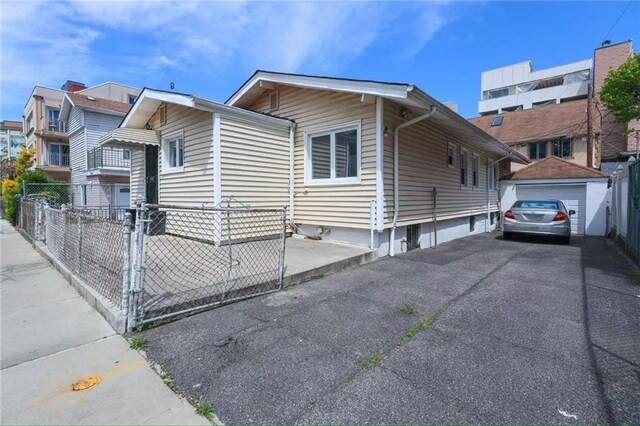 2939 Brighton 3rd St, Brooklyn, NY 11235 - view of front of home featuring a garage and fence