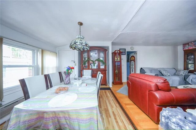 2939 Brighton 3rd St, Brooklyn, NY 11235 - dining area with light wood-style floors, a baseboard heating unit, and a notable chandelier