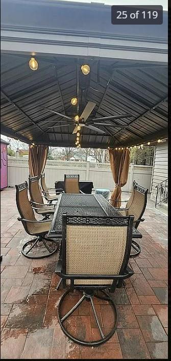 view of patio with outdoor dining space, a gazebo, and fence