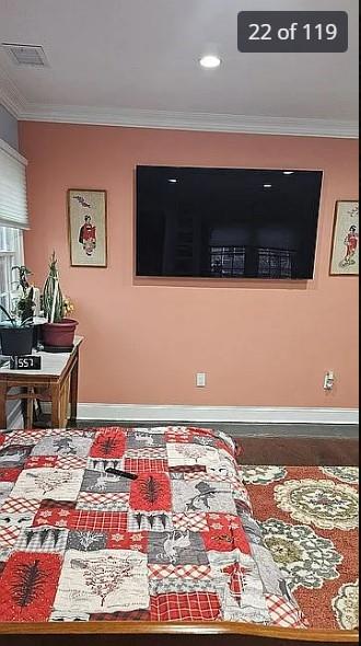 bedroom featuring baseboards and crown molding