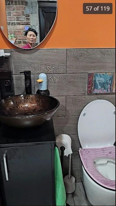half bathroom with vanity and toilet