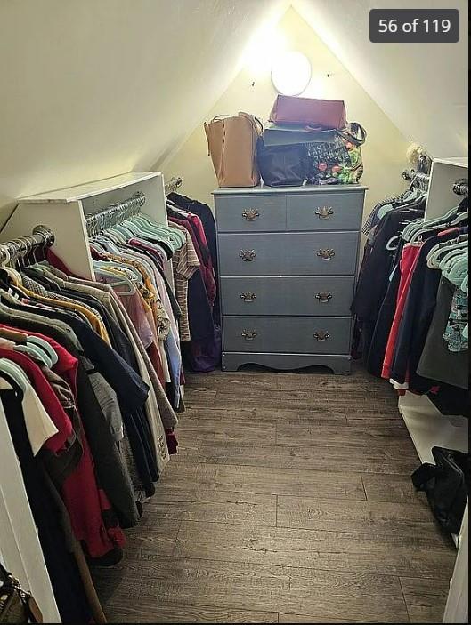 spacious closet featuring dark wood-style flooring and lofted ceiling