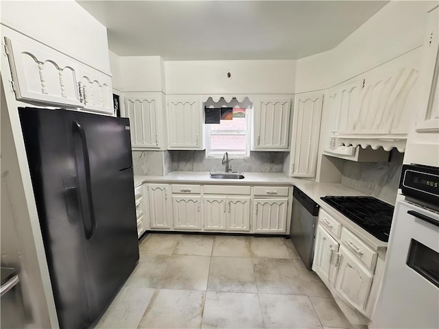 2518 W 1st St, Brooklyn, NY 11223 - kitchen with black appliances, a sink, backsplash, light countertops, and white cabinets