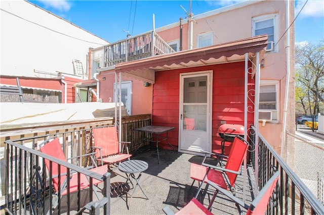 266 Wakeman Pl, Brooklyn, NY 11220 - back of house featuring stucco siding and a balcony