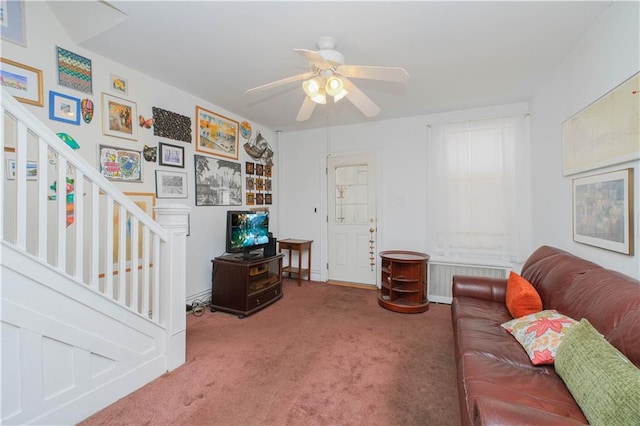 266 Wakeman Pl, Brooklyn, NY 11220 - living room featuring radiator heating unit, carpet, a ceiling fan, baseboards, and stairs