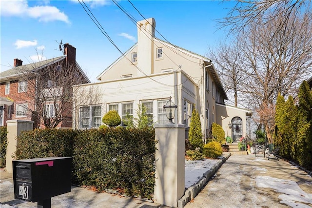 view of side of property with stucco siding