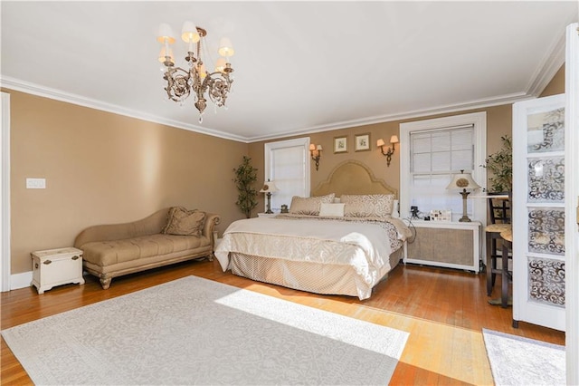 bedroom with an inviting chandelier, ornamental molding, and wood finished floors