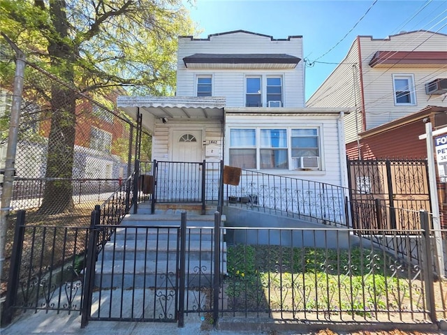 1462 E 92nd St, Brooklyn, NY 11236 - view of front of home featuring a fenced front yard, a gate, and a wall mounted air conditioner
