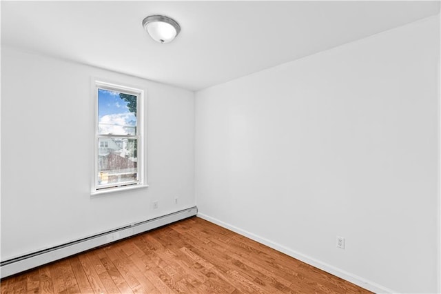 1462 E 92nd St, Brooklyn, NY 11236 - unfurnished room featuring a baseboard heating unit, light wood-style floors, and baseboards