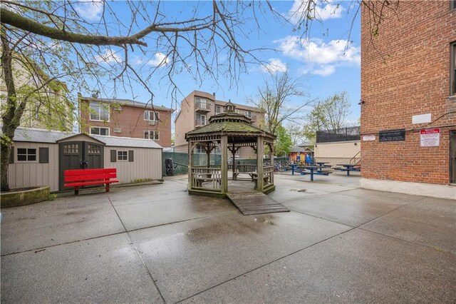 2800 Coyle St Unit 318, Brooklyn, NY 11235 - view of community featuring a gazebo, an outdoor structure, a patio area, and a storage shed