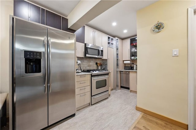 2800 Coyle St Unit 318, Brooklyn, NY 11235 - kitchen featuring recessed lighting, stainless steel appliances, light wood-style floors, backsplash, and baseboards