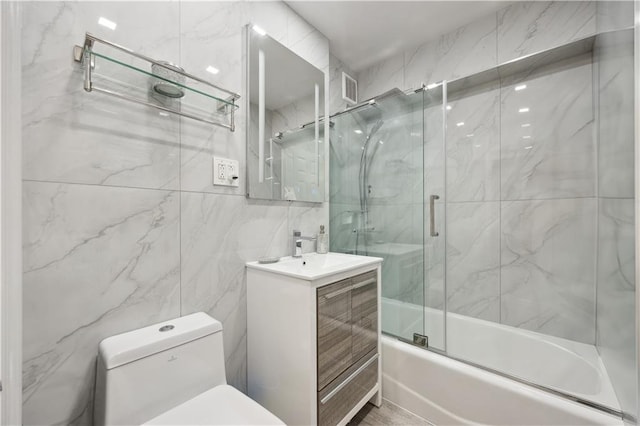 2800 Coyle St Unit 318, Brooklyn, NY 11235 - bathroom with tile walls, enclosed tub / shower combo, toilet, vanity, and visible vents