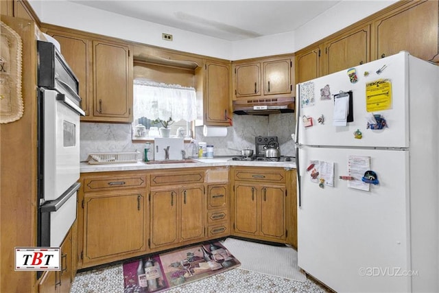 1378 E 93th St, Brooklyn, NY 11236 - kitchen featuring white appliances, under cabinet range hood, brown cabinetry, and light countertops