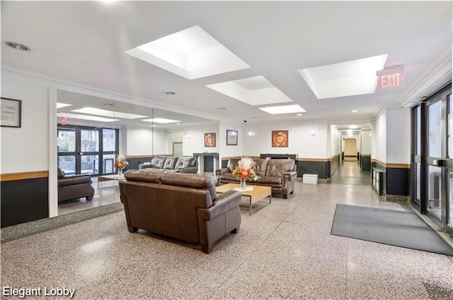lobby featuring ornamental molding and a wainscoted wall
