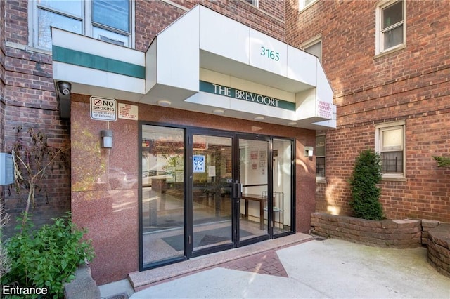 entrance to property with brick siding
