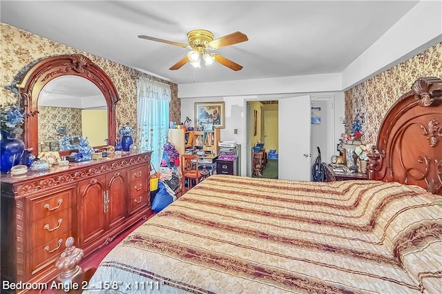 bedroom with wallpapered walls and ceiling fan