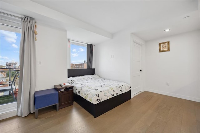 623 H Ave Unit 7C, New York, NY 11230 - bedroom with light wood finished floors, access to outside, and baseboards