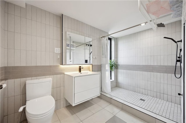 623 H Ave Unit 7C, New York, NY 11230 - full bath featuring tile walls, vanity, a shower stall, tile patterned flooring, and toilet