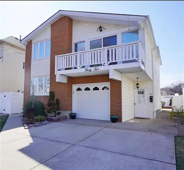 32 Dickie Ave, Staten Island, NY 10314 - view of front of property featuring a balcony, a garage, driveway, and brick siding