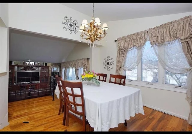32 Dickie Ave, Staten Island, NY 10314 - dining room featuring a chandelier, wood finished floors, and lofted ceiling