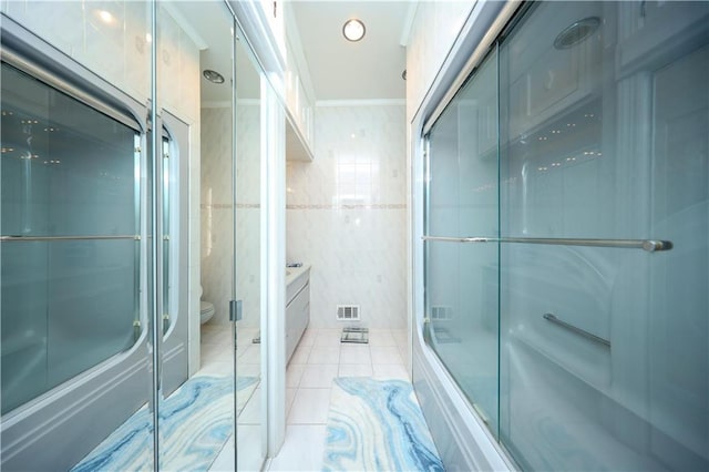 bathroom featuring tile patterned flooring, a shower stall, tile walls, toilet, and visible vents