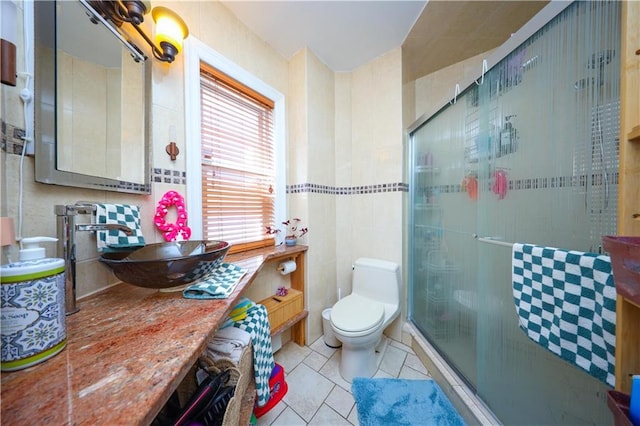 bathroom with a shower stall, toilet, tile patterned flooring, and vanity