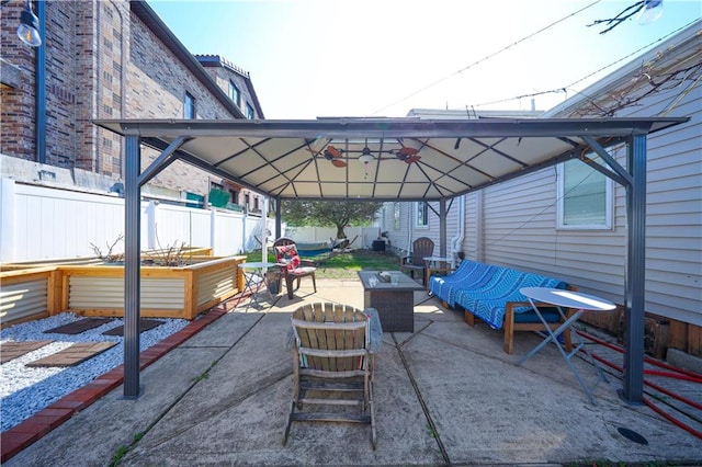 view of patio / terrace featuring an outdoor living space, a gazebo, and a fenced backyard