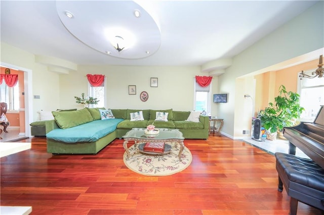 living room with wood finished floors and a healthy amount of sunlight