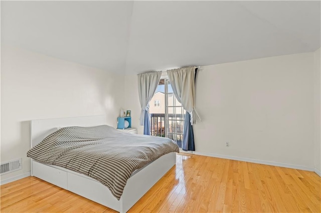 bedroom featuring visible vents, wood finished floors, and baseboards