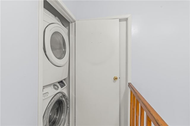 laundry room featuring stacked washer and dryer and laundry area