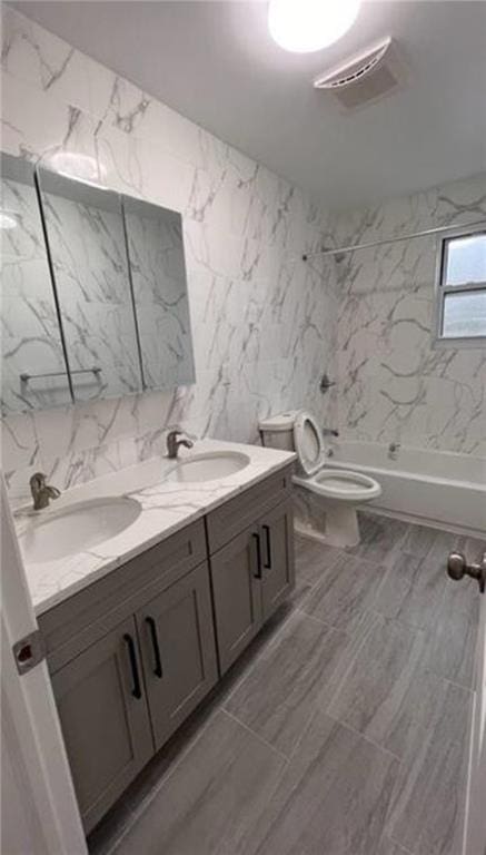 bathroom with double vanity, toilet, shower / bathtub combination, and a sink