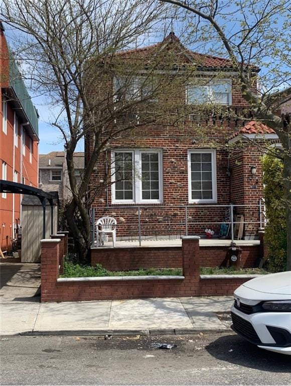 view of front of house featuring brick siding and fence private yard