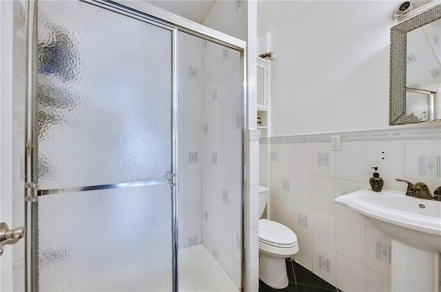 1639 Hendrickson St, Brooklyn, NY 11234 - bathroom with a stall shower, tile patterned floors, tile walls, and wainscoting