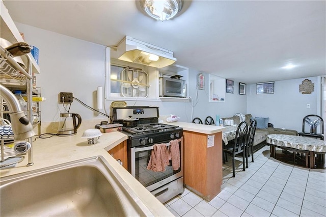 1639 Hendrickson St, Brooklyn, NY 11234 - kitchen with appliances with stainless steel finishes, light countertops, light tile patterned flooring, and under cabinet range hood