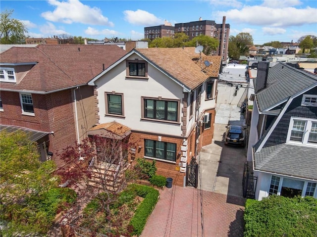 1639 Hendrickson St, Brooklyn, NY 11234 - view of front of home featuring stucco siding, concrete driveway, a gate, and brick siding