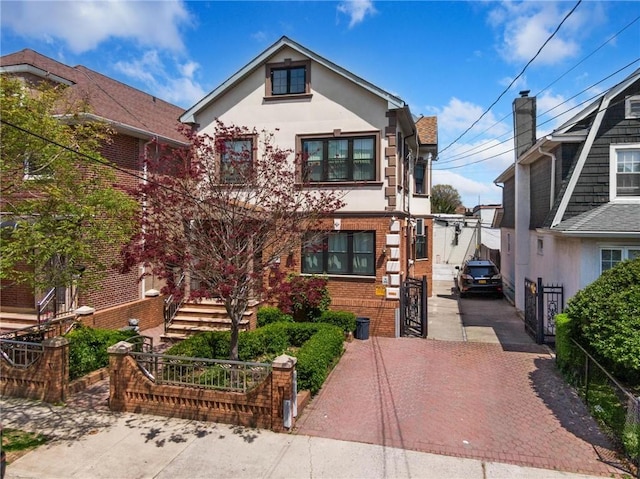 1639 Hendrickson St, Brooklyn, NY 11234 - tudor house featuring stucco siding, brick siding, and decorative driveway