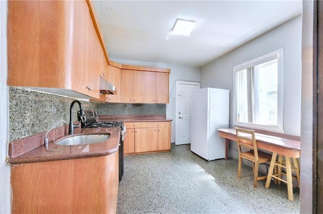 1639 Hendrickson St, Brooklyn, NY 11234 - kitchen featuring freestanding refrigerator, gas stove, light brown cabinets, under cabinet range hood, and backsplash
