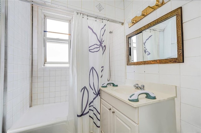 bathroom featuring vanity, tile walls, and shower / tub combo with curtain