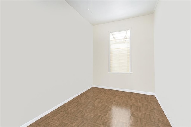 unfurnished room with baseboards