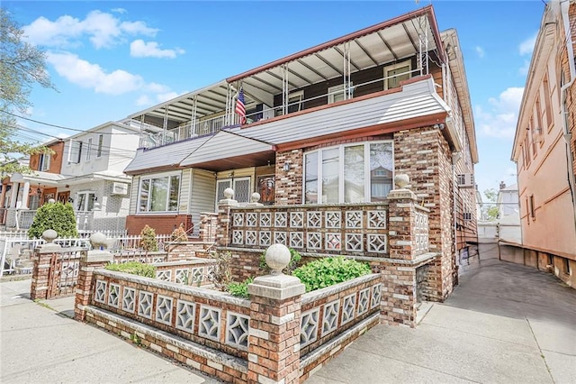townhome / multi-family property with brick siding